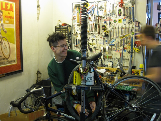 man in bike repair shop