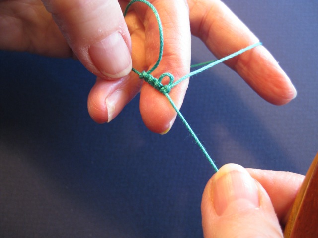 fingers holding thread